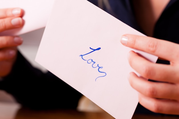 Woman is holding a love letter