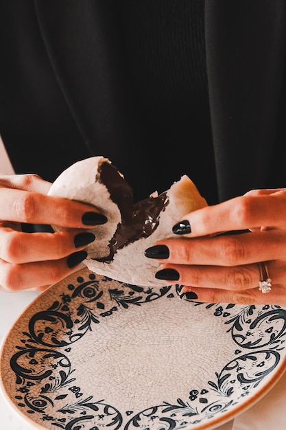 a woman is holding a piece of cake with a ring on it