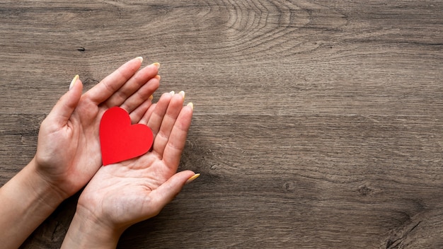 Woman is holding a red heart