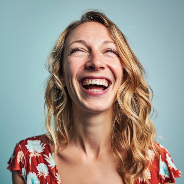 A woman is laughing and looking up at the camera