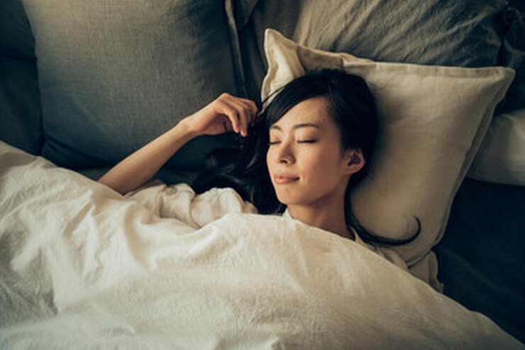 Photo 女性がその上に文字が書かれた枕を持ってベッドに横たわっています