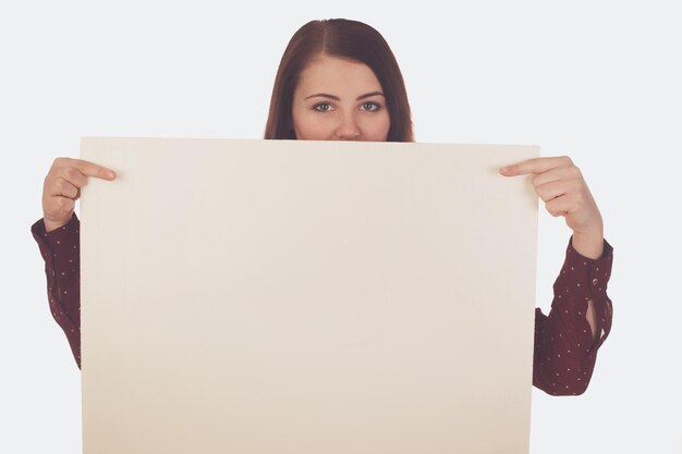 Woman is looking out of a blank canvas