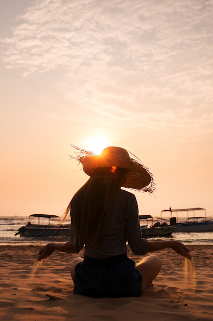 The woman is pouring sand