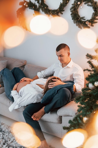 Woman is pregnant Lovely couple celebrating holidays together indoors