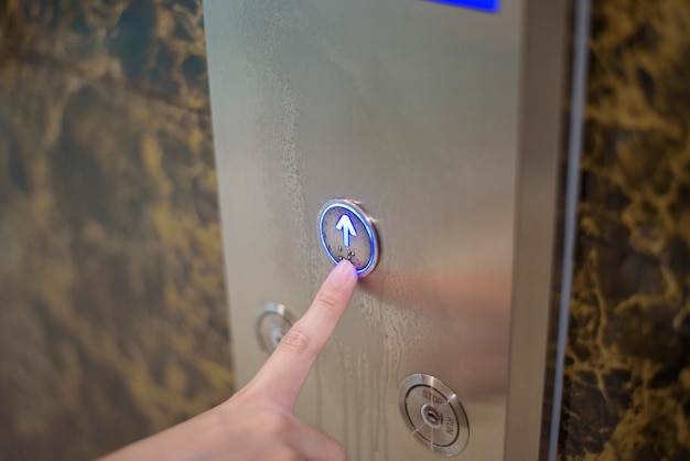 Woman is pushing elevator button