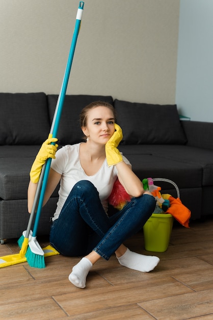 Woman is ready to clean house. A housewife is cleaning house