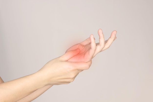 Woman is rubbing her palm cause from numb or pain