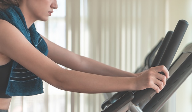 Woman is running on treadmill in home fitness