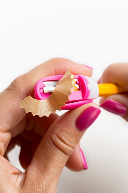 Woman is sharpening the pencil