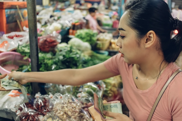 Woman is shopping in Thai local fresh market.