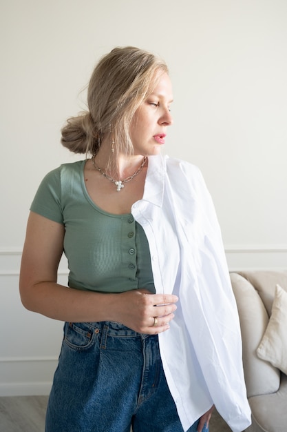 The woman is showing off a white shirt.