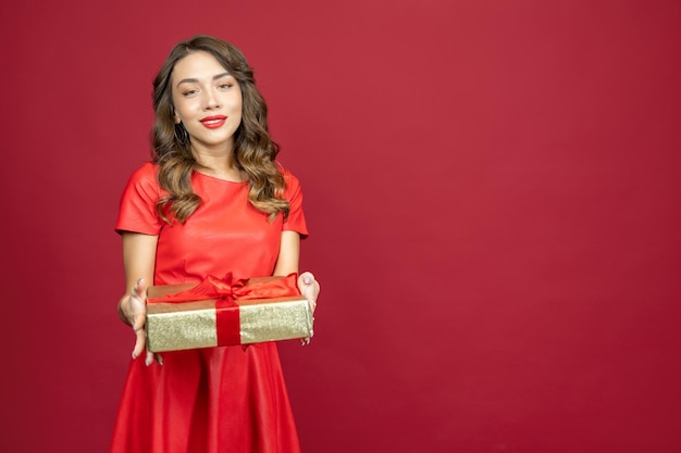 Woman is smiling gratefully on a red background