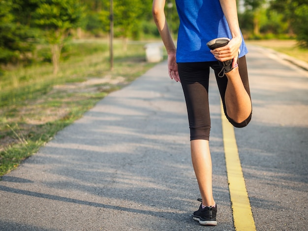 Woman is stretching before jogging