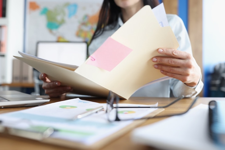 Photo woman is studying financial business documents at her desk