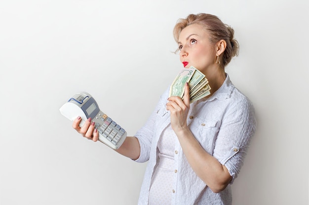 The woman is surprised looking at the calculator