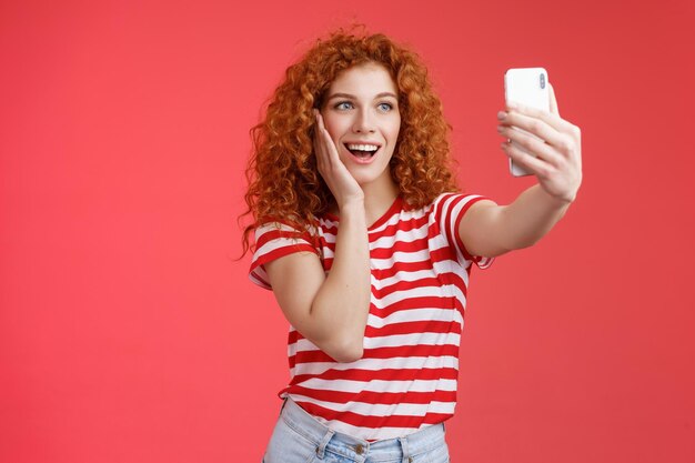 a woman is taking a selfie with a phone