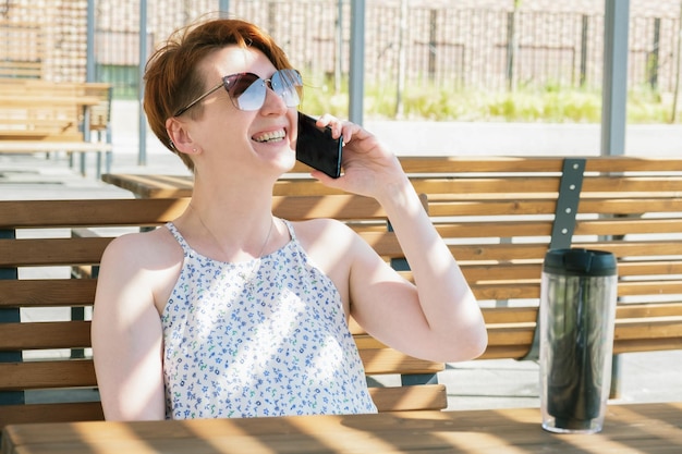 Woman is talking on a mobile phone and smiling