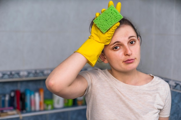 a woman is tired after cleaning the bathroom.