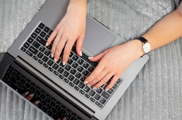 The woman is typing on the keyboard View from above