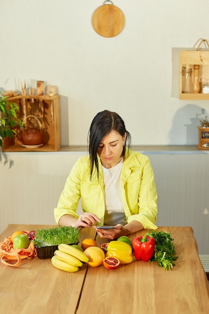 Woman is using smarthone, looking recipe