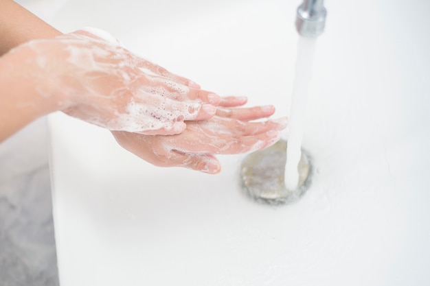 A woman is washing hands