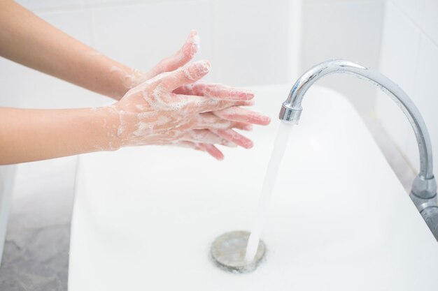 A woman is washing hands