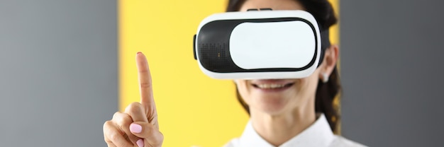Woman is wearing virtual glasses she holds her thumbs up.