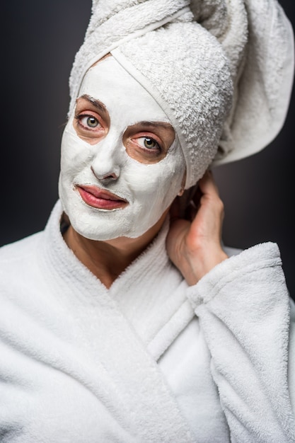 Woman is white clay on his face mask