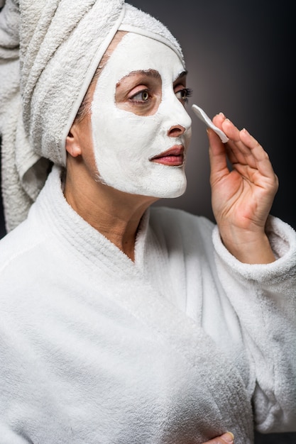 Woman is white clay on his face mask