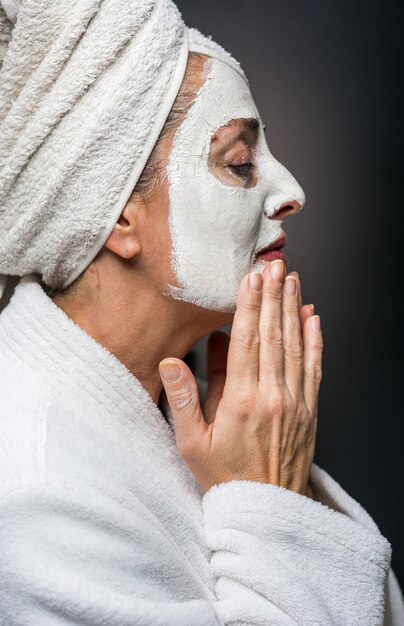 Woman is white clay on his face mask