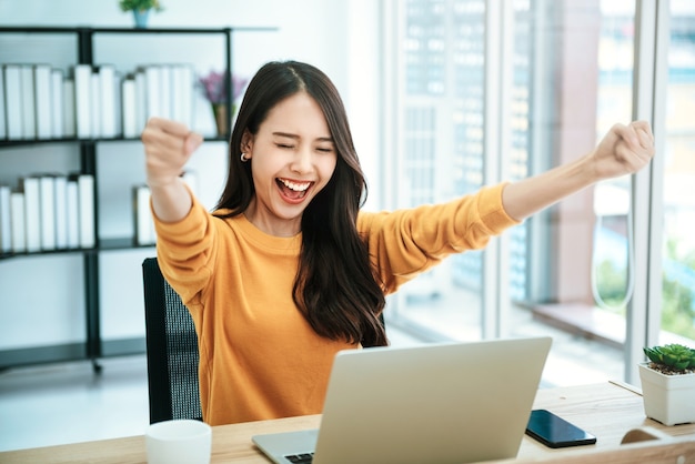 女性は自宅でラップトップを使用しています