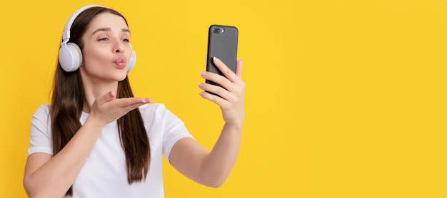 Woman isolated face portrait banner with copy space woman making selfie on smartphone listening