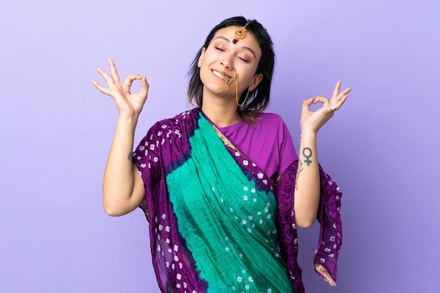 woman isolated on purple in zen pose