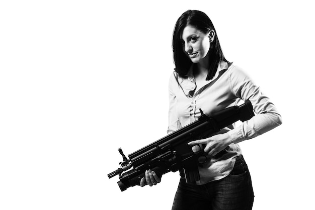 Woman Isolated on a White Background With a Handgun as She Turns and Aims Off Camera