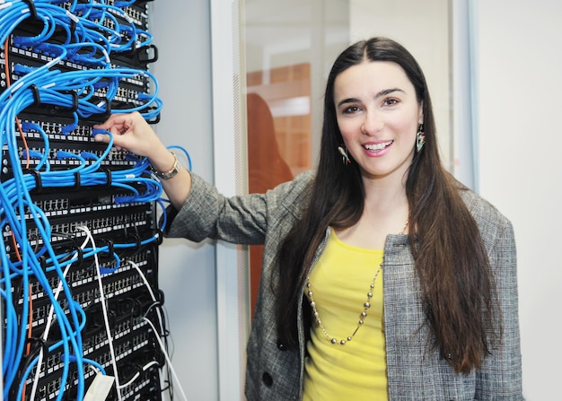 Woman it engineer in network server room solving problems and give help and support