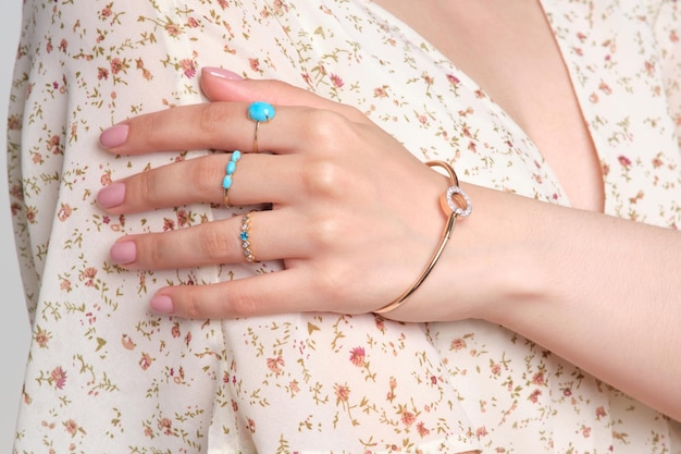 Woman Jewelery concept Woman hands close up wearing rings earrings and necklace modern accessories elegant life style