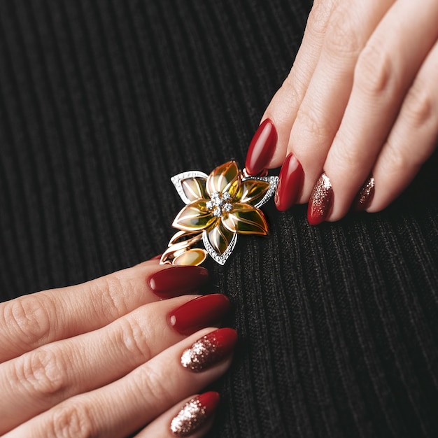 Woman Jewelery concept Woman hands close up wearing rings earrings and necklace modern accessories elegant life style