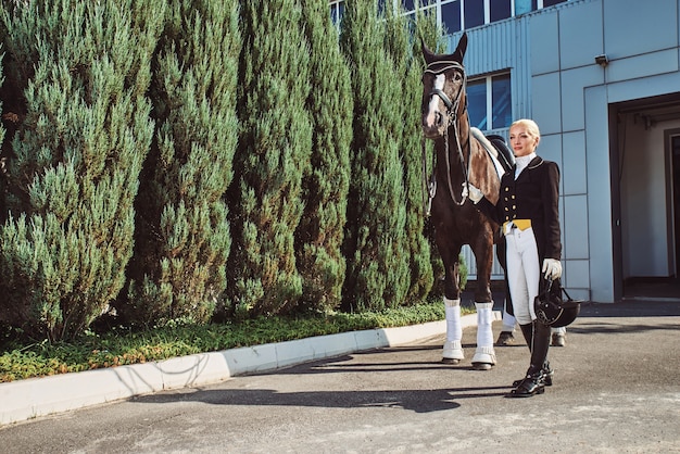 Woman jockey with his horse