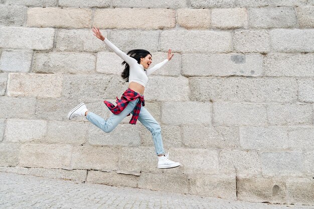 Woman jumping joyfully with open arms