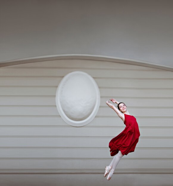 Woman jumping in a red dress