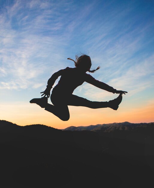 Woman jumping at sunset