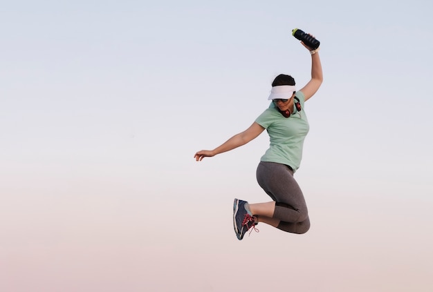 Woman jumping while doing sport