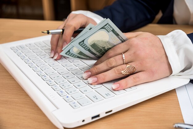 Woman keeps the hands in dollars