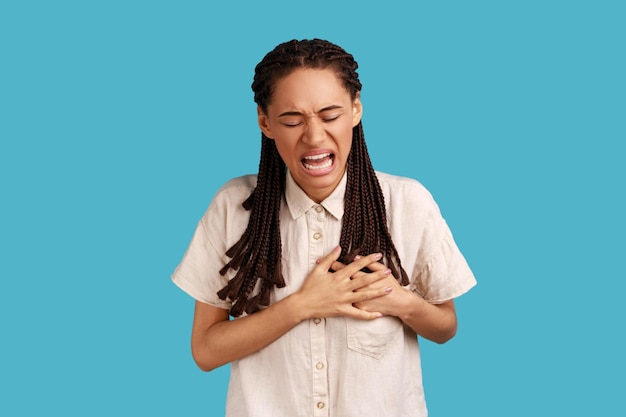 Photo woman keeps hands near chest suffers from heart attack has problems with health