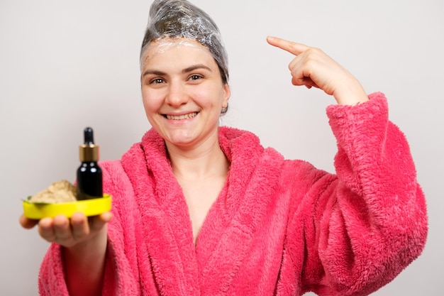 A woman keeps natural cosmetics for hair care