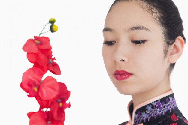 Woman in kimono looking at orchids