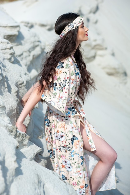 A woman in a kimono sits on a rock