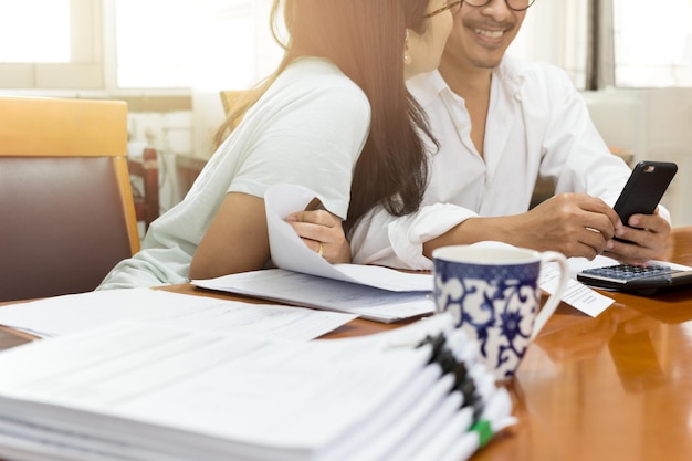 Woman kissing man by table at home