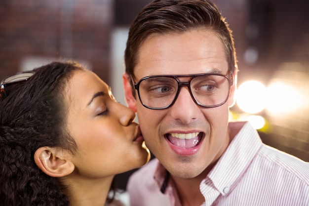 Woman kissing man on cheek