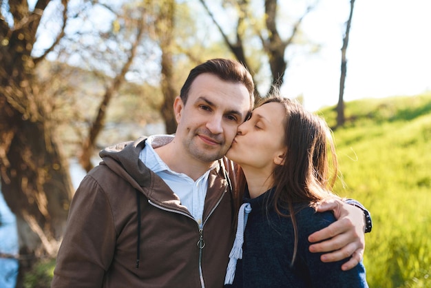 Woman kissing man in cheek